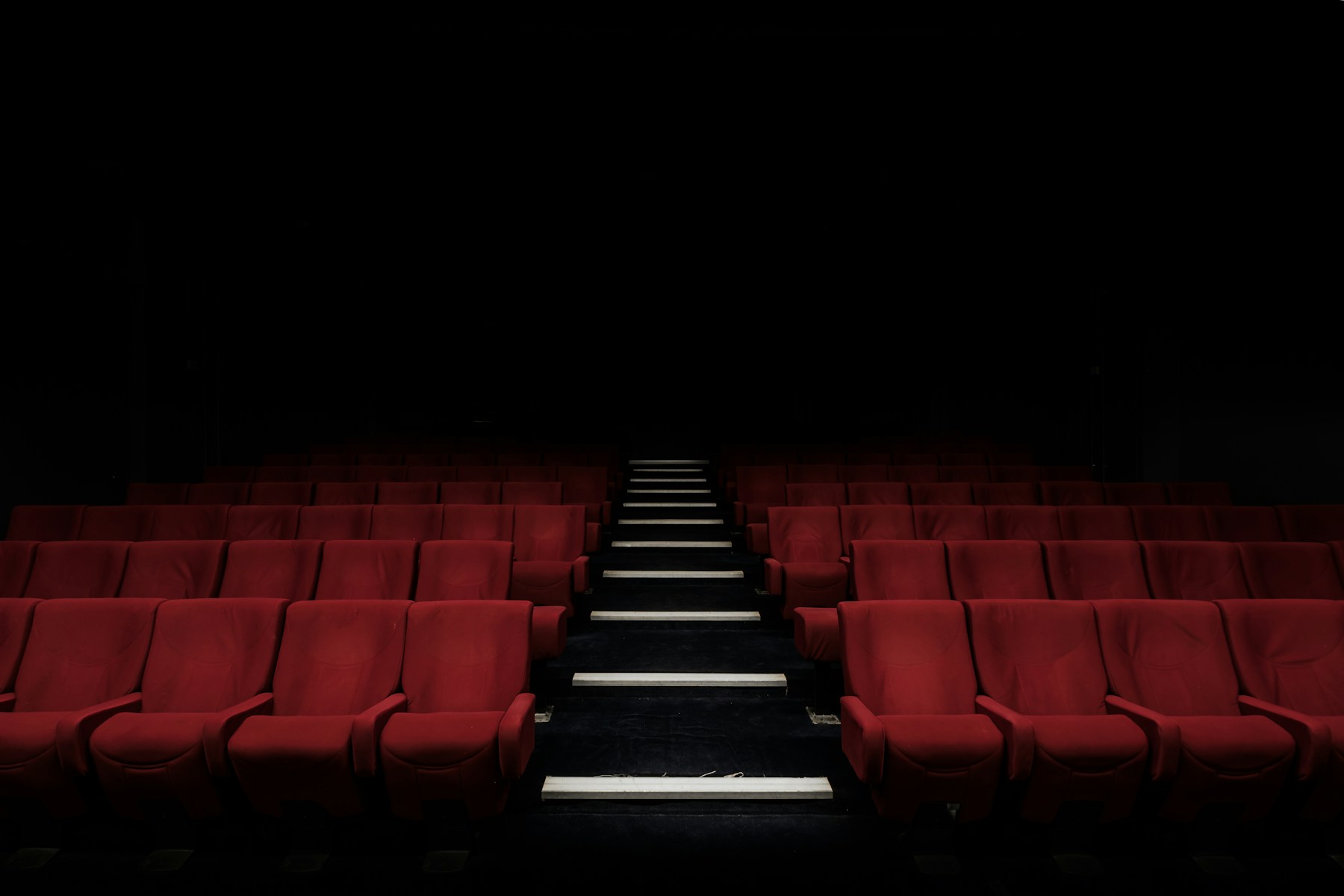 Dark screening room with cinema seats